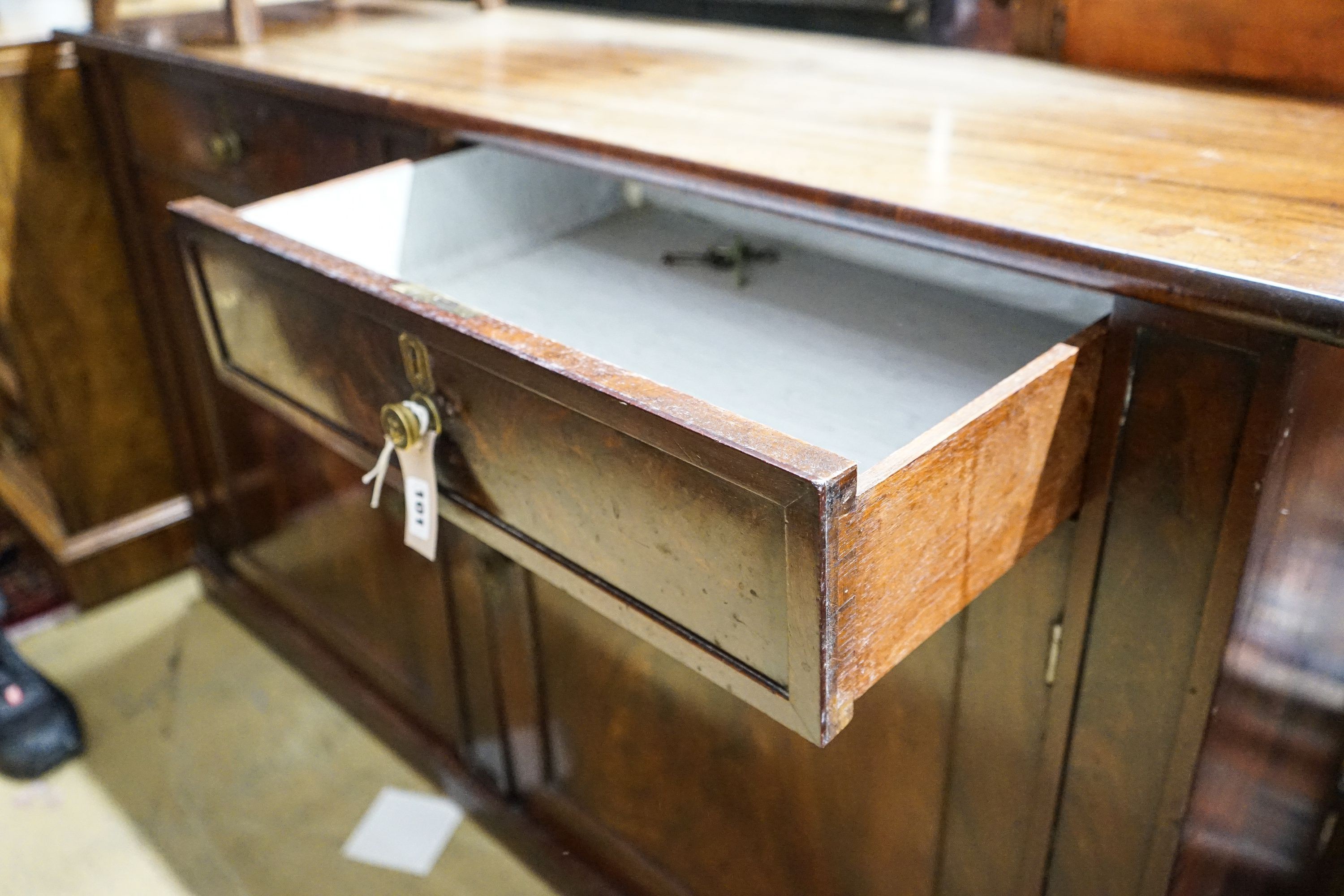 A Regency mahogany low cabinet fitted with two drawers, over a pair of cupboard doors and plinth base, width 138cm, depth 43cm, height 76cm
